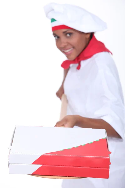 A pizza cook shoveling pizza boxes — Stock Photo, Image