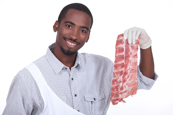 Butcher with a rack of ribs — Stock Photo, Image