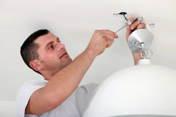 Man fixing light at home — Stock Photo, Image