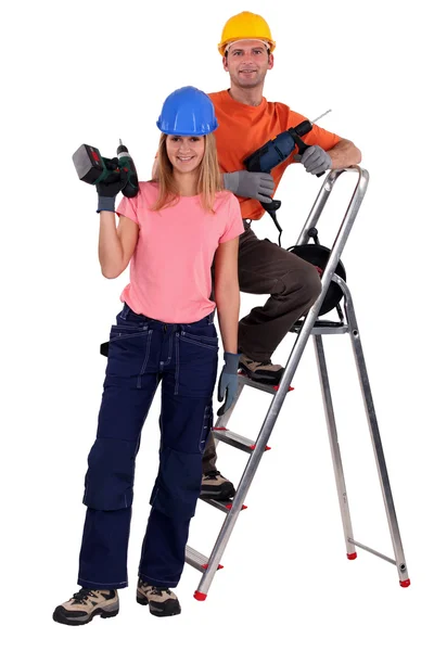 Couple de travailleurs avec perceuses électriques — Photo