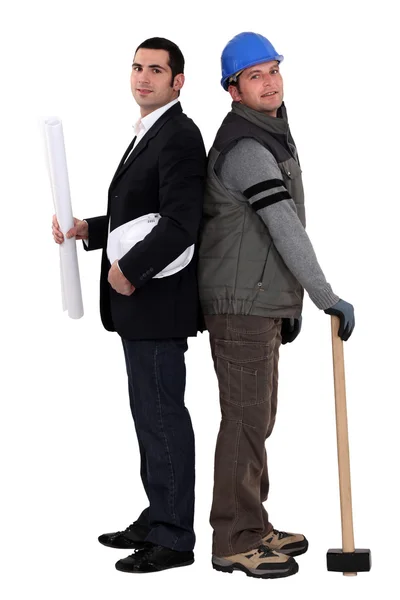 Architect and foreman standing back to back on white background — Stock Photo, Image