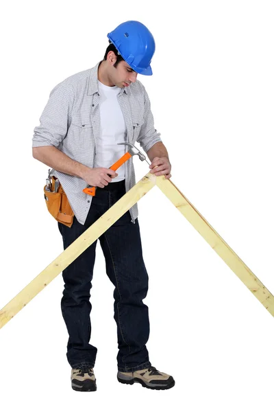 Tradesman nailing a frame — Stock Photo, Image