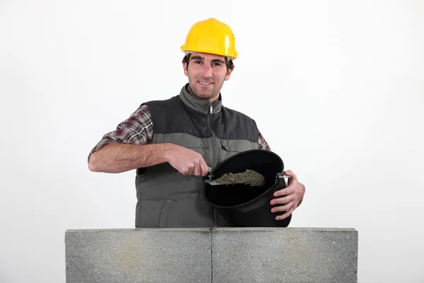 Bricklayer with a bucket of cement — Stock Photo, Image