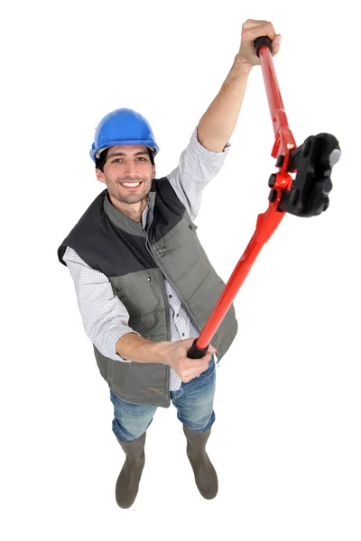 Een mannelijke bouwvakker met een tang. — Stockfoto