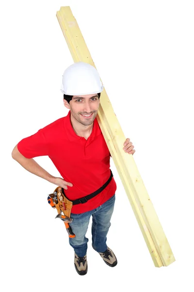 High angle shot portrait of craftsman carrying lumber — Stock Photo, Image