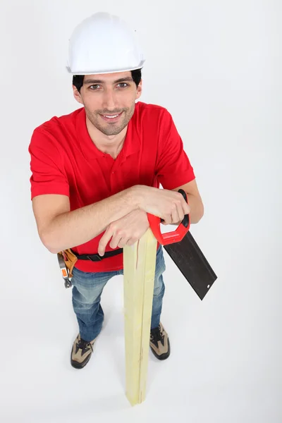 Smiling carpenter with a saw — Stock Photo, Image
