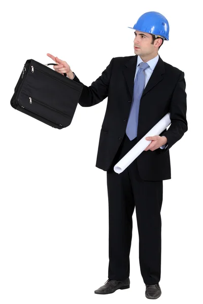Engineer holding a briefcase and blueprint — Stock Photo, Image