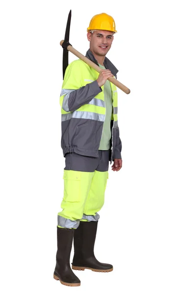 Portrait of bricklayer standing with pickaxe over his shoulder — Stock Photo, Image