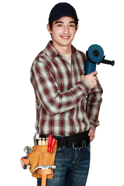 Young apprentice with a grinder. — Stock Photo, Image