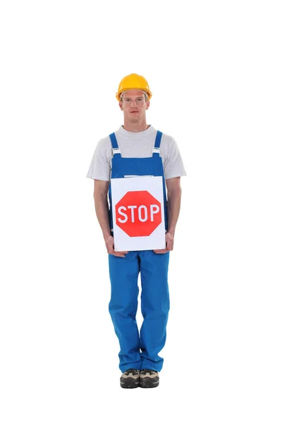 Construction worker with a stop sign — Stock Photo, Image