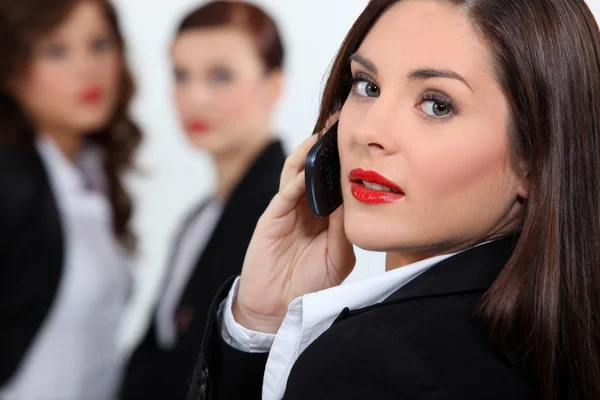 Affärskvinna i rött läppstift med hjälp av en mobiltelefon — Stockfoto