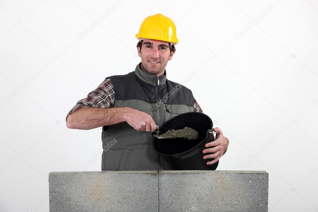 Bricklayer with a bucket of cement Stock Photo by ©photography33 8128440