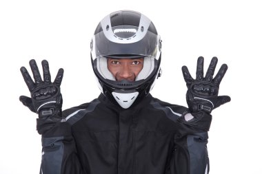 Motorcyclist wearing black jacket, gloves and helmet clipart