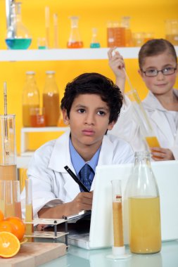 Kids performing science experiment clipart