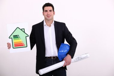 Construction businessman holding an energy consumption label clipart