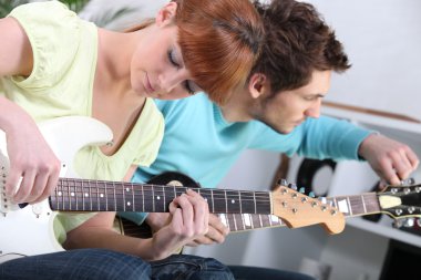 Teenagers playing the guitar clipart