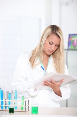 Blond woman in science laboratory clipart