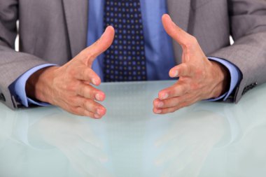 Closeup on businessman's hands during speech clipart