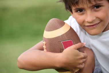 Young boy playing rugby clipart