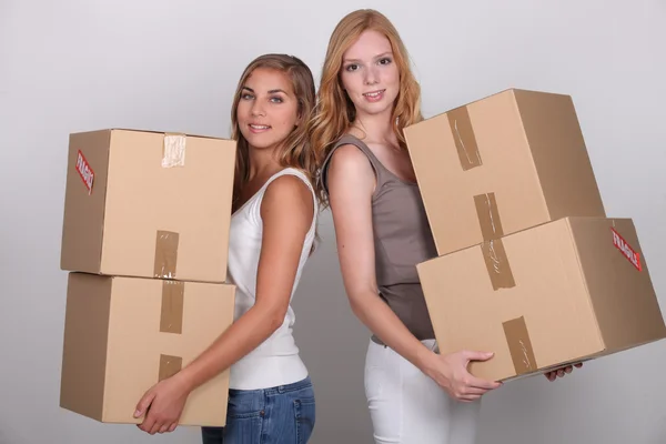 Girls carrying boxes — Stock Photo, Image