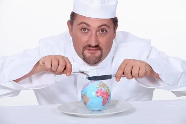 Пухнастий кухар їсть трохи глобуса — стокове фото