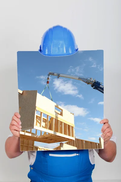 Ansiktslösa arbetare visar en byggnad webbplats bild — Stockfoto