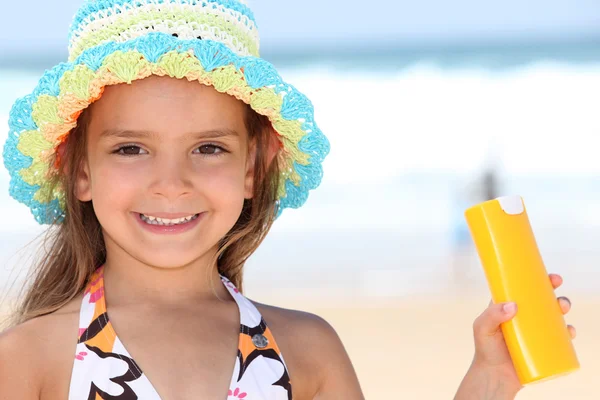 Girl holding sun-cream — Stock Photo, Image