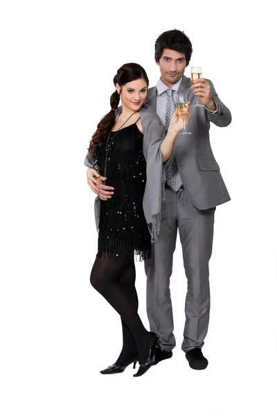 Smart couple holding champagne glasses — Stock Photo, Image