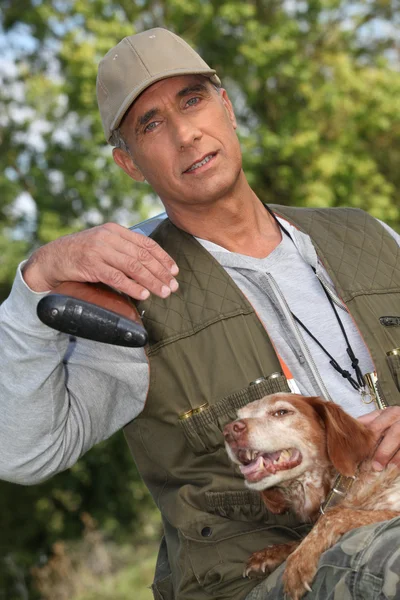 Jager poseren met hond buiten — Stockfoto
