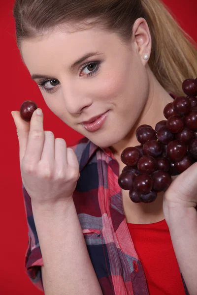 魅力的な女性はブドウを食べる — ストック写真