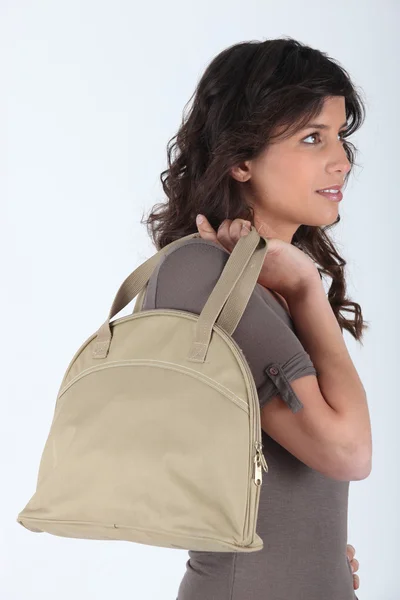 Portrait of a young woman with handbag — Stockfoto