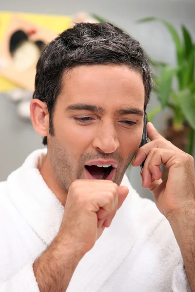 Homem bocejando no telefone — Fotografia de Stock