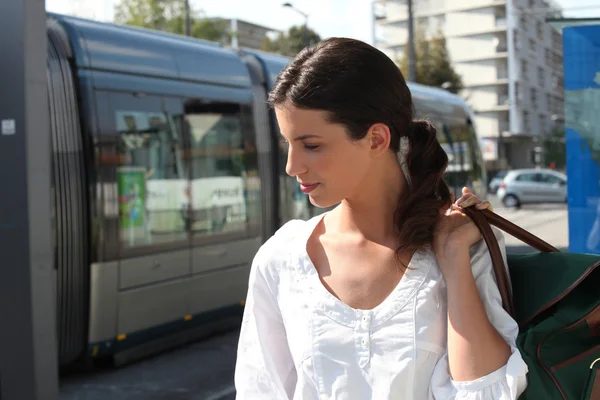Молодая женщина ждет трамвай — стоковое фото