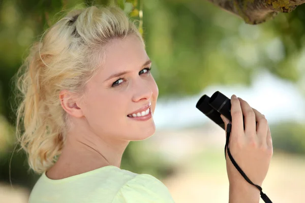 Unga blonda kvinnan med kikare — Stockfoto