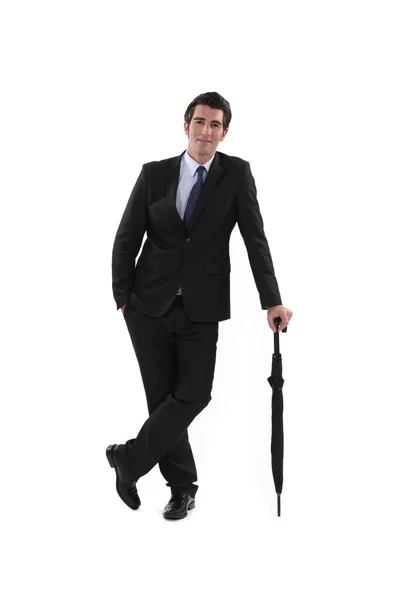 Businessman holding umbrella — Stock Photo, Image
