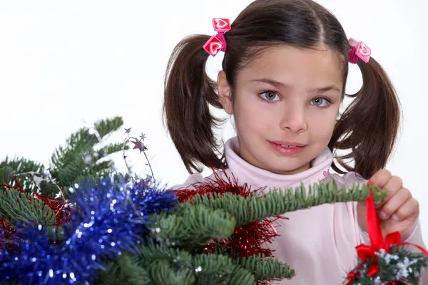 Young girl decorating a Christmas tree Stock Picture