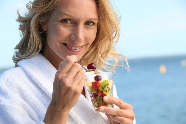 Portrait of a woman eating fruit salad Royalty Free Stock Images