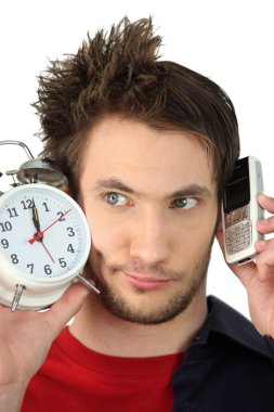 Man with alarm clock and mobile phone clipart