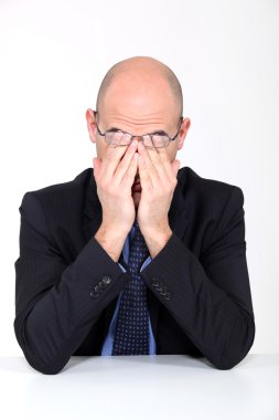 Tired man rubbing his eyes clipart