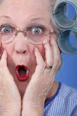 Shocked old lady wearing hair rollers clipart