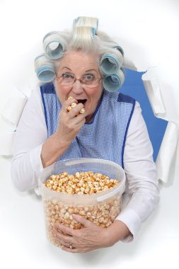 Elderly lady eating popcorn clipart