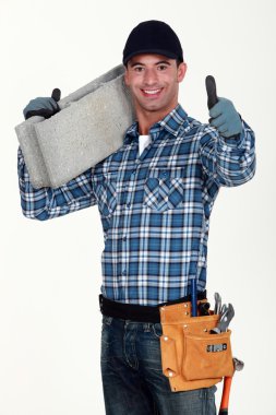 Builder carrying building block clipart