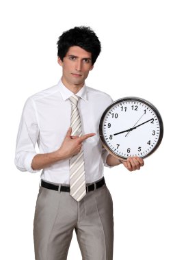 Office worker pointing his finger to a clock clipart