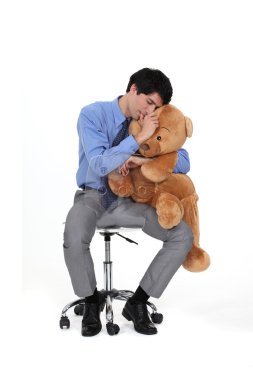 Businessman hugging teddy bear clipart