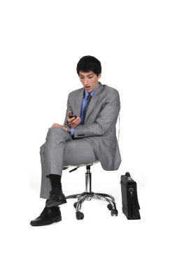 Businessman shocked at his cellphone clipart