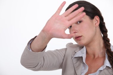 Woman trying to block out the camera clipart