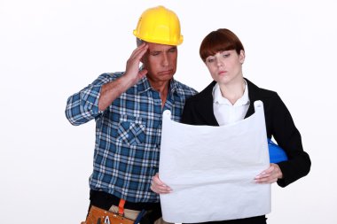 Architect and builder discussing plans clipart