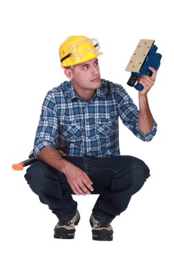 Worker with an electric sander clipart