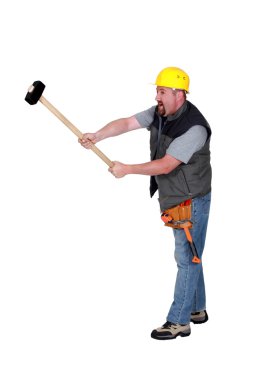 A construction worker with a sledgehammer. clipart