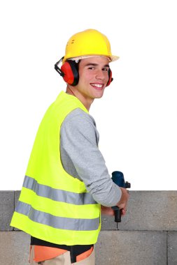 Man drilling into breeze blocks clipart